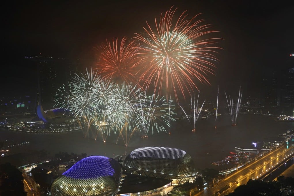 Fireworks explode above Singapore's financial district at the stroke of midnight to mark the New Year's celebrations on Monday, Jan. 1, 2018, in Singapore. (AP Photo/Wong Maye-E)