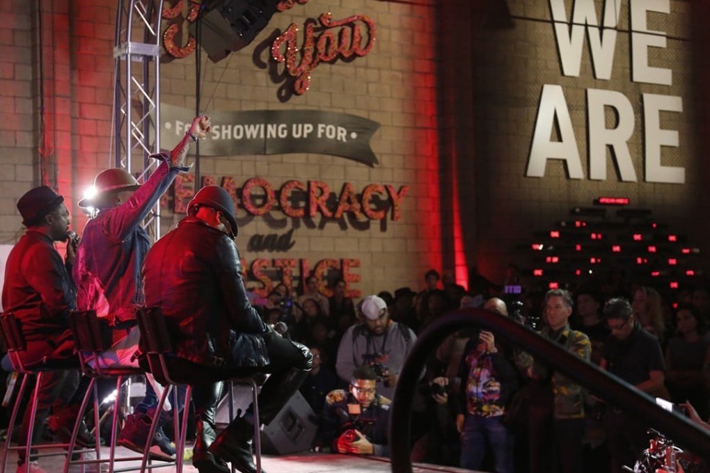 will.i.am, Taboo and apl.de.ap of The Black Eyed Peas address the crowd at Into Action in Los Angeles. Photo: TNS