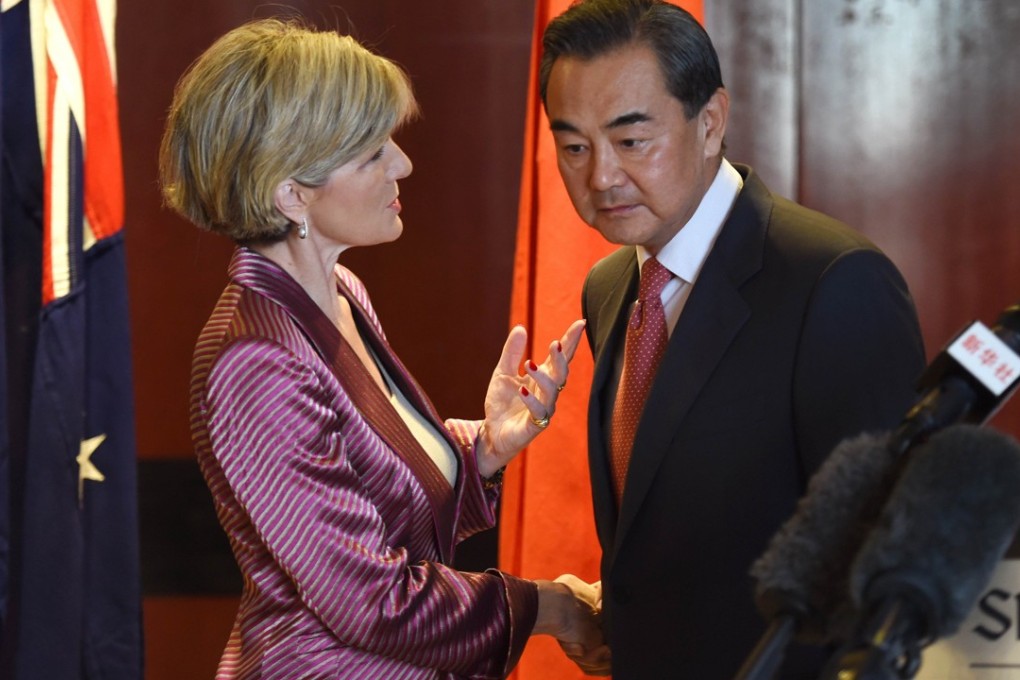 Australian Minister for Foreign Affairs Julie Bishop and Chinese Foreign Minister Wang Yi shake hands in Sydney on September 7, 2014. Photo: AFP