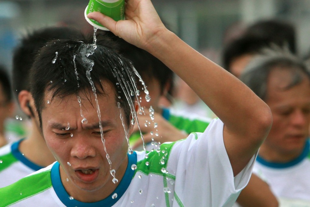Runners take on water at the drink station during the Hong Kong Marathon in 2010. Photo: Felix Wong