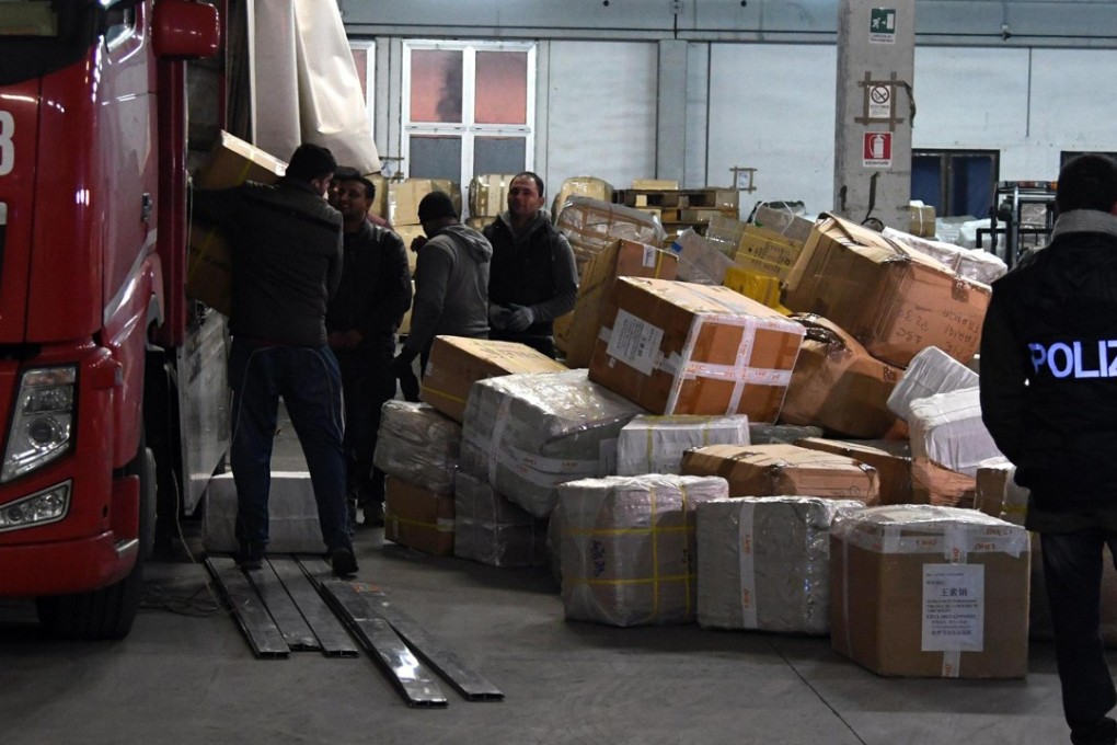 Italian police check merchandise during an operation against the Chinese mafia called “China truck” in Prato, Italy, on Thursday. Photo: EPA