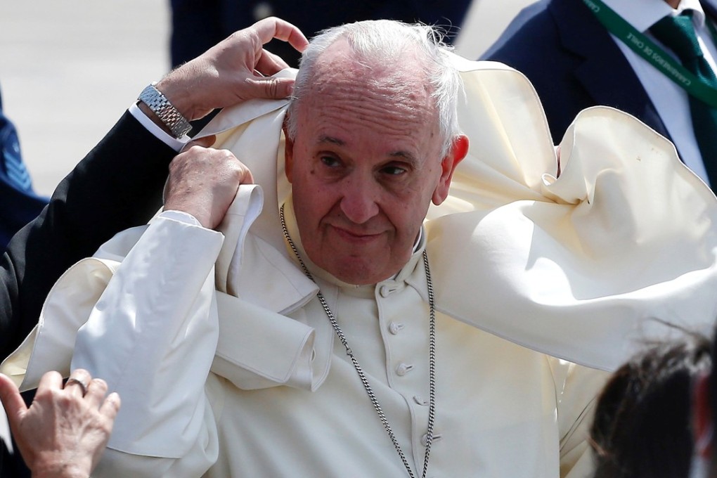 A gust of wind blows Pope Francis' mantle as he departs to Peru from Iquique, Chile, on Wednesday. He strongly defended a Chilean bishop accused of covering up the abuse of minors by a priest during his visit to the country. Photo: Reuters