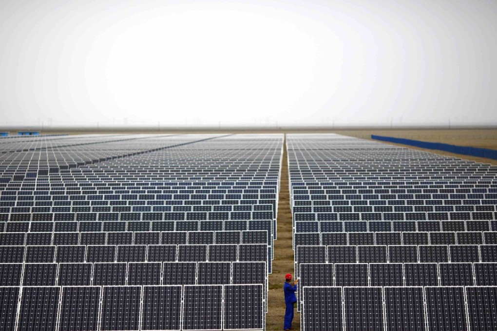 A worker inspects panels at a solar farm in Dunhuang, Gansu province, in 2013. Environmental targets have been incorporated into the country’s economic planning since 2006. Photo: Reuters