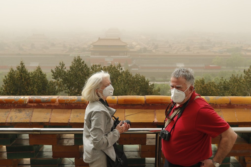 Tourists wear face masks on a visit to Jingshan Park in Beijing. Air quality improved across China in 2017, the environmental protection ministry said on Thursday. Photo: Xinhua