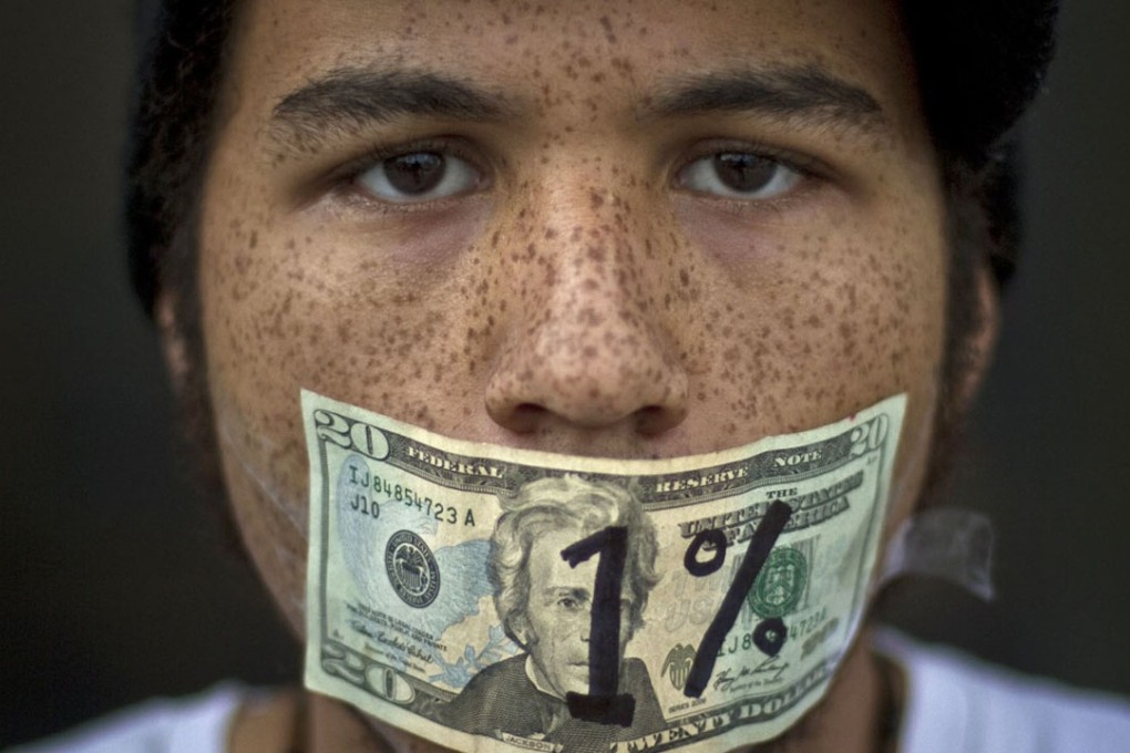A demonstrator protests against income inequality in Denver, Colorado, in 2011.The recent US tax cuts are expected to benefit the wealthy and hit the needy hard. Photo: Reuters