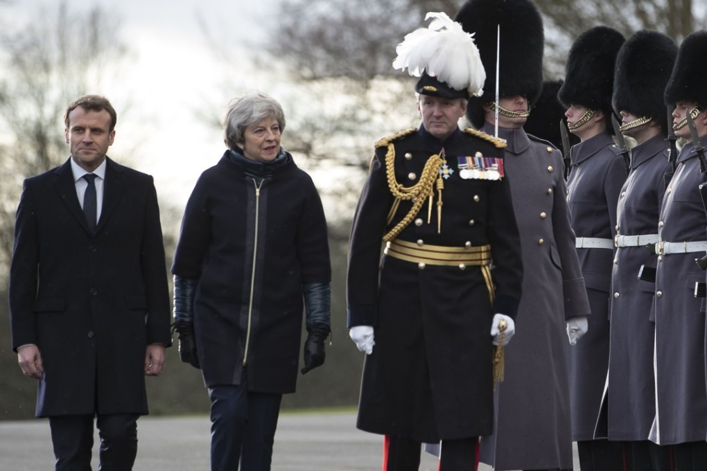 French President Emmanuel Macron (left) and Britain's Prime Minister Theresa May arrive to review an honour guard at the Royal Military Academy Sandhurst, west of London on Thursday. The military-tinted meeting was a signal that western Europe’s two most powerful countries would continue to support one another after Brexit. Photo: AFP