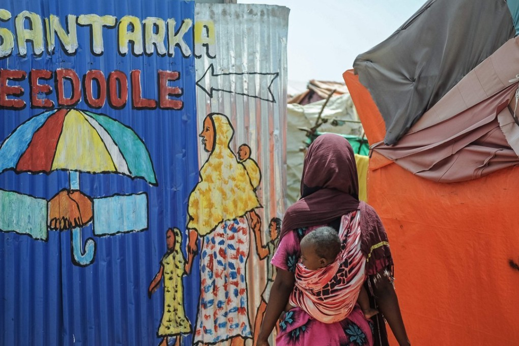 A Somali woman enters to Wedeo refugee camp. The Wedow refugee camp, considered the largest refugee camp in Mogadishu, was created for refugees fleeing from the al-Qaeda affiliated al-Shabab militants. Photo: AFP