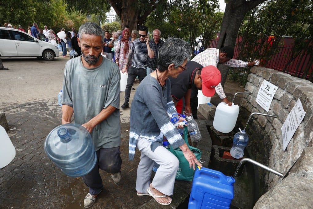 Residents of Cape Town collect drinking water from a mountain spring. Photo: EPA