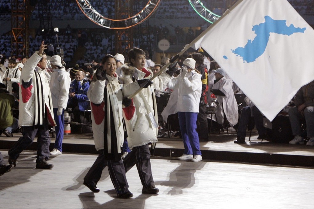 Korea flag-bearers Lee Bora and Lee Jong-In carry a unification flag into the stadium during the 2006 Winter Olympics opening ceremony in Turin, Italy. Photo: AP