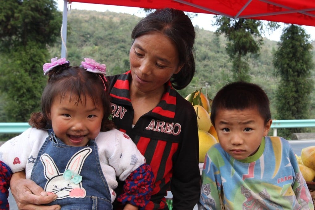 A grandmother takes care of her grandchildren in Guizhou province. Photo: Simon Song