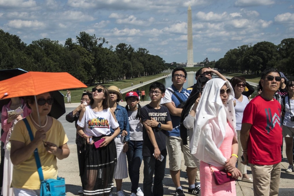 A group of Chinese tourists at the Washington Monument on the National Mall in Washington DC on August 24, 2016. As many as 3 million Chinese tourists visited the United States, spending US$33 billion, more than the spending by Canadian and Mexican tourists combined. Photo: Washington Post/Jabin Botsford.