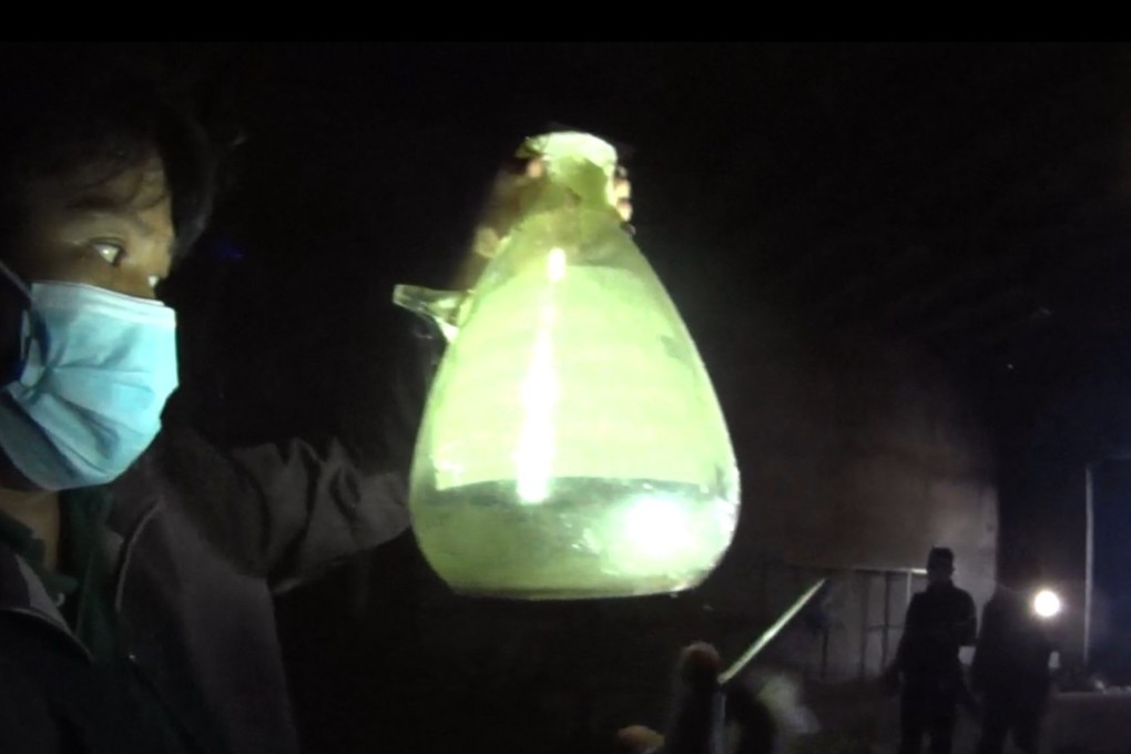 PDEA chemist Jhomar Concepcion holding a beaker containing methamphetamine. Photo: SCMP