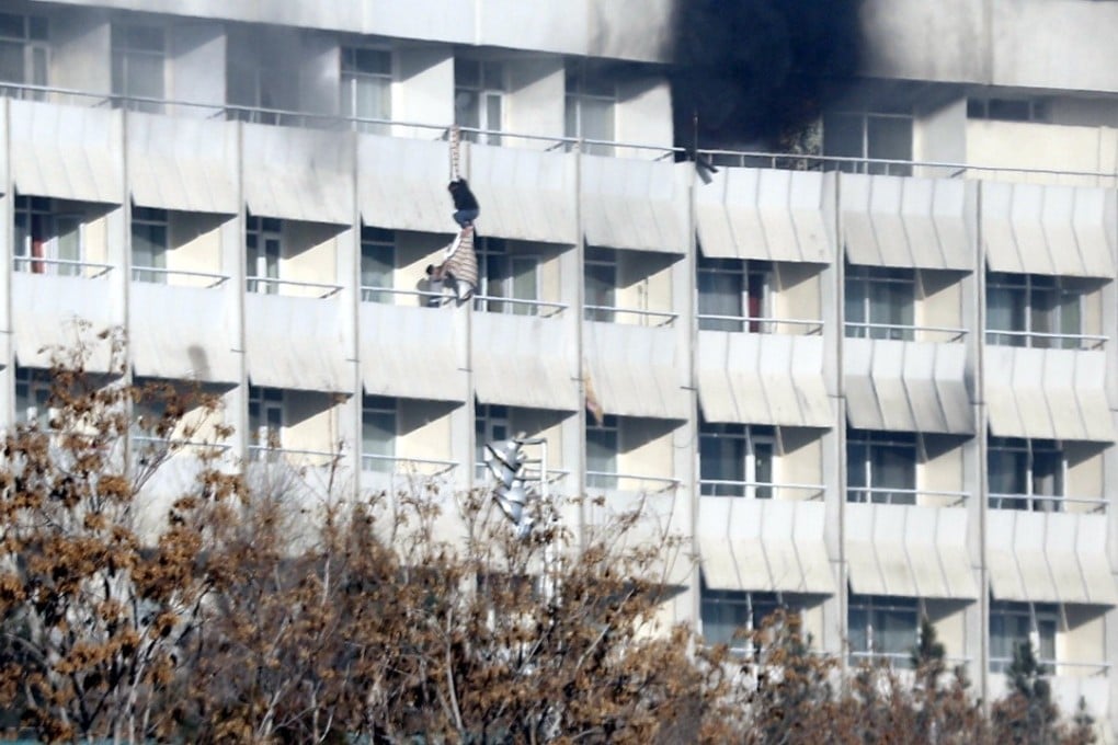 People use fabric to jump from the Intercontinental Hotel after an attack by armed gunmen in Kabul. Photo: EPA