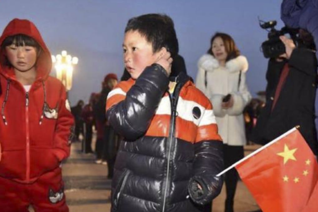 “Ice Boy” Wang Fuman, 8, attends the flag-raising ceremony in Tiananmen Square on Saturday with his sister Wang Fumei, 10. Photo: Baijiahao.baidu.com