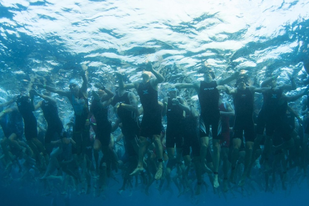 Triathletes awaiting the start of their 2.4 miles (3.86km) swim portion, the first part of a swim-bike-run race during the Ironman World Championship in Kailua-Kona in Hawaii on October 12, 2013. Dalian Wanda Group, the Chinese property-to-theme-park conglomerate, bought the World Triathlon Corp., which owns the rights to the race, in 2015. Photo: Reuters