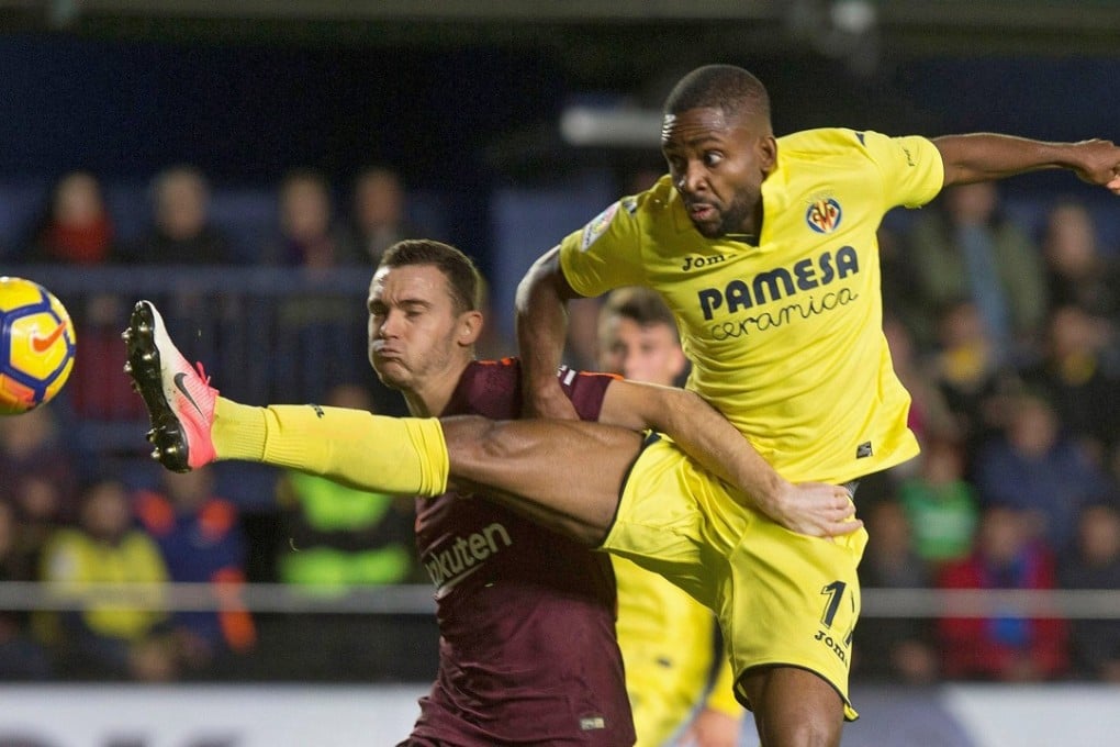 Villareal's Cedric Bakambu wins the ball ahead of Barcelona’s Thomas Vermaelen in their La Liga. Photo: EPA