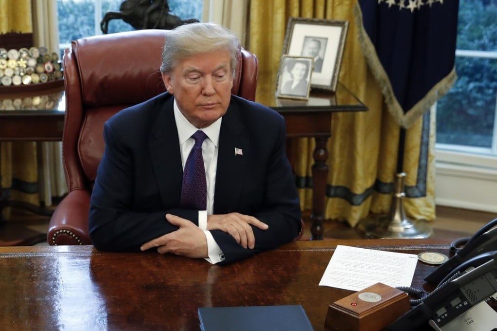 President Donald Trump sits at the Resolute Desk in the Oval Office on Tuesday. He has rejected a bipartisan deal created by Republican and Democratic senators in the wake of the government shutdown. Photo: AP
