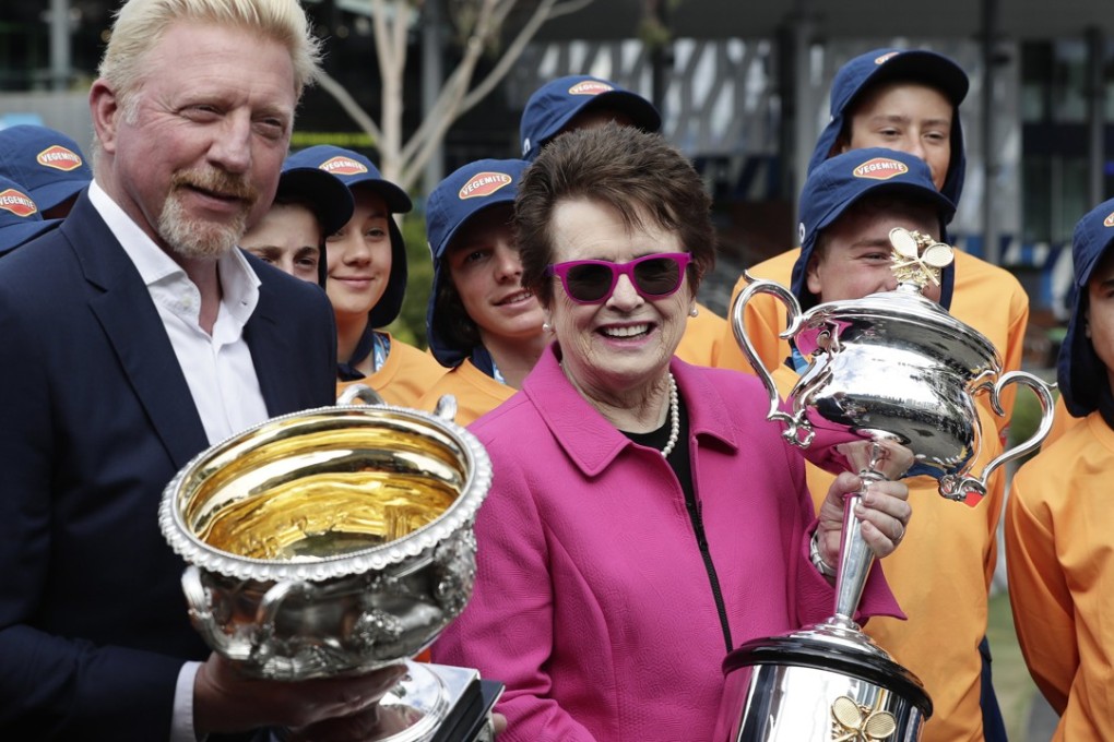 Former tennis champions Boris Becker (left) and Billie Jean King (right) carry the trophies on the opening day of the Australian Open. Photo: EPA