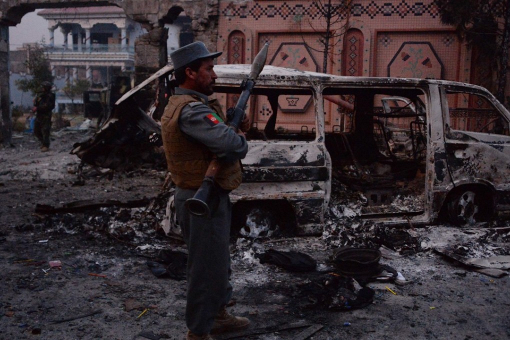 Afghan security forces inspect the site of attack on British charity Save the Children office in Jalalabad on Wednesday. Photo: AFP