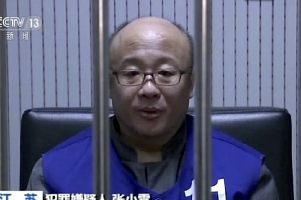 A still from state television shows the founder of the Ponzi scheme, Zhang Xiaolei, behind bars. Photo: Associated Press