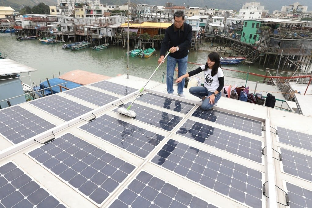 Villagers of Tai O clean up solar panels as part of a project in their community. Photo: Dickson Lee
