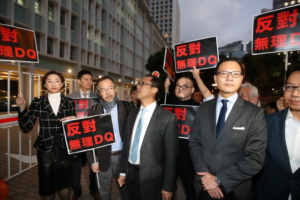 Pan-democrats waited outside justice secretary Teresa Cheng’s office to demand an explanation for why two pro-democracy activists had not yet been confirmed as candidates for the March 11 by-election. Photo: Edward Wong