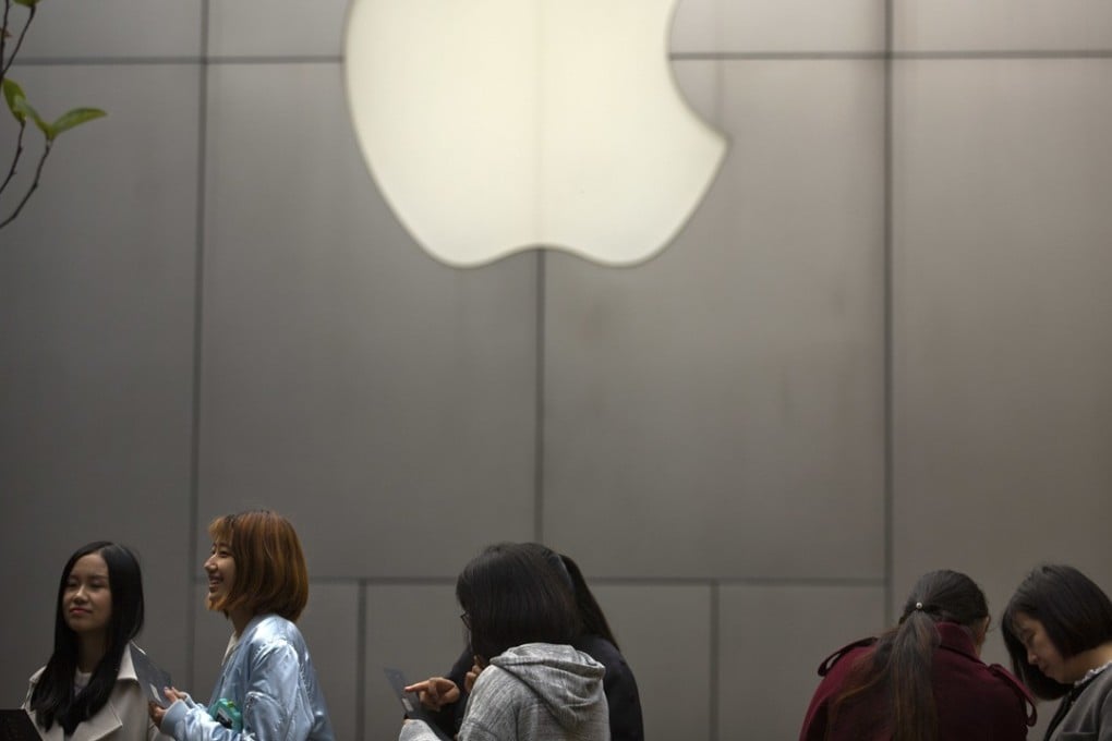 People stand in line near an Apple Store at an outdoor shopping centre in Beijing, China. Photo: AP