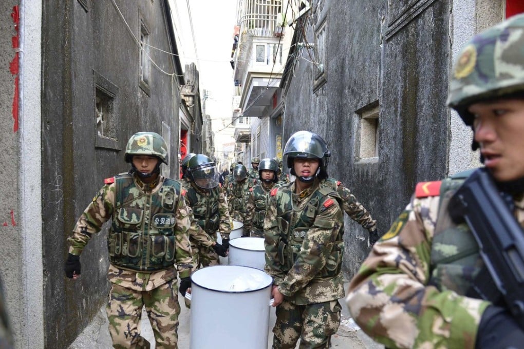 Paramilitary policemen carry crystal meth seized in Lufeng in Guangdong province. Narcotics are one of many areas targeted in Beijing’s new campaign. Photo: AFP