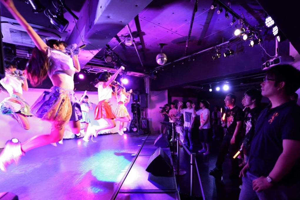 Adults watch a concert by an idol group in Tokyo. Photo: AFP