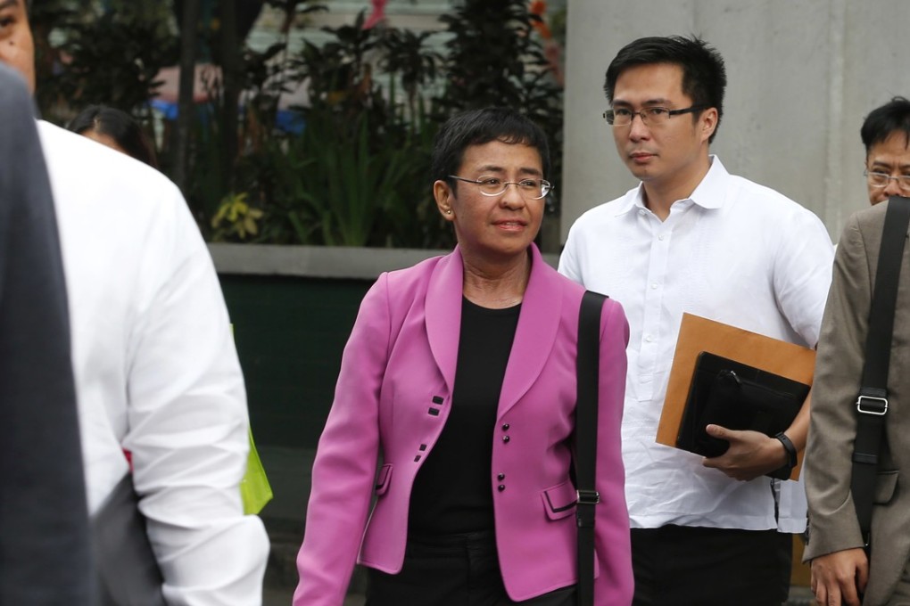 Maria Ressa, centre, CEO of the online news agency Rappler, walks with her lawyers to the National Bureau of Investigation on January 22, 2018. The UN urged the Philippines to preserve free media after the Philippine securities commission revoked the registration of Rappler, known for its critical reporting on Philippine President Rodrigo Duterte, a move media watchdogs said is an act to muzzle the free press. Photo: AP