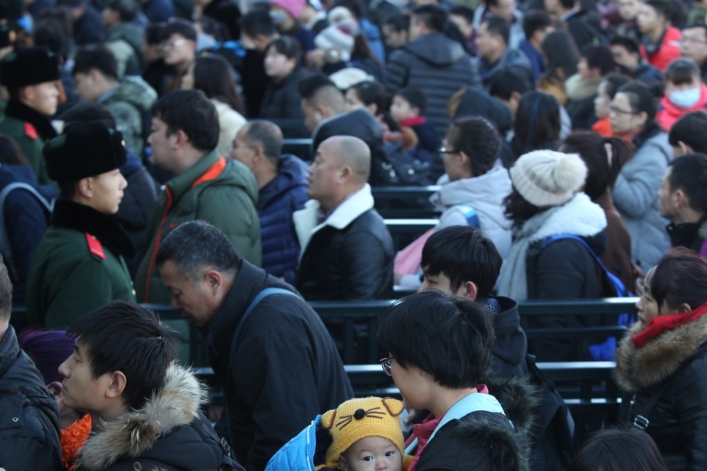 Travellers line up to enter the Beijing Railway Station for the coming Lunar New Year Festival in Beijing on January 13, 2017. Photo: Simon Song