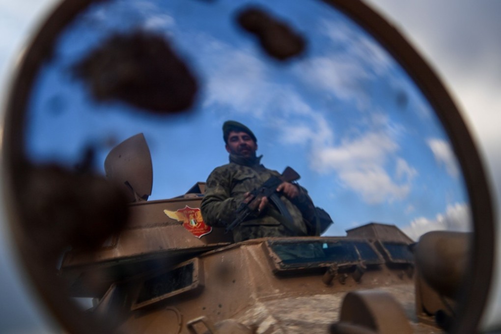 A Turkish-backed Syrian rebel fighter at a checkpoint in the Syrian town of Azaz on a road to Afrin. Photo: AFP