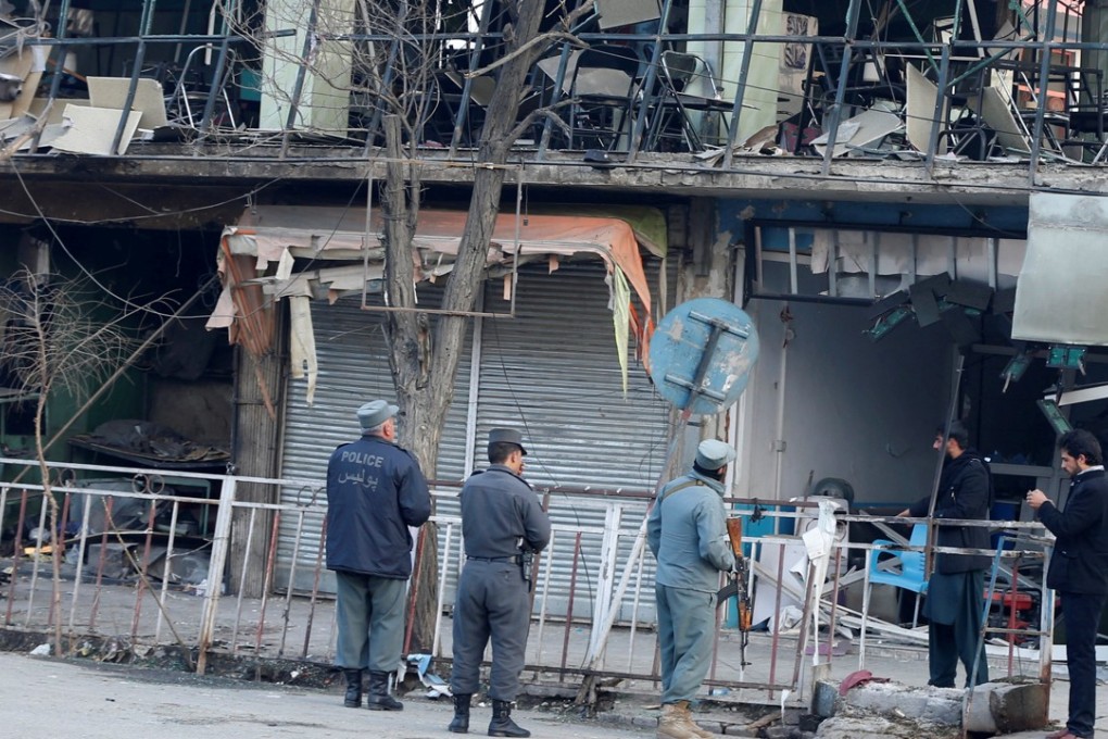 Afghan police inspect the bomb site in Kabul. Photo: Reuters