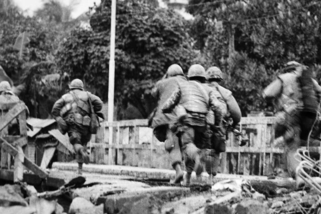 US marines sprint through the rubble of the citadel in Hue, South Vietnam, after its walls were breached by tank fire in February, 1968. Photo: Alamy