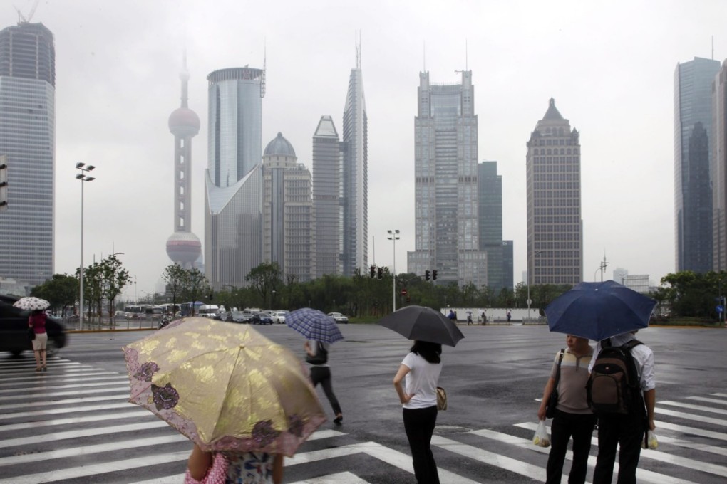 Pedestrians walk through the Lujiazui financial district in Shanghai. China is stepping up its crackdown on banks’ irregularities. Photo: EPA