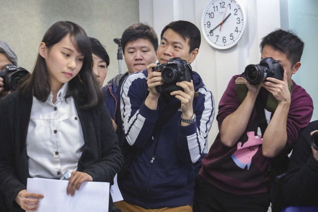 By-election candidate Agnes Chow Ting (left) in Mong Kok responding to questions about her disqualification on Saturday. Photo: Felix Wong