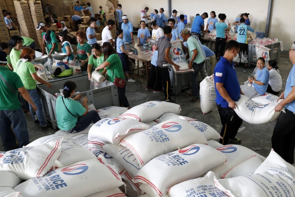 Volunteers in Pasay City in the Philippines repack relief goods for families affected by a typhoon, at a government storage facility. While the social ecosystem surrounding philanthropy in Asia is robust, governments could do more to encourage systematic giving. Photo: EPA