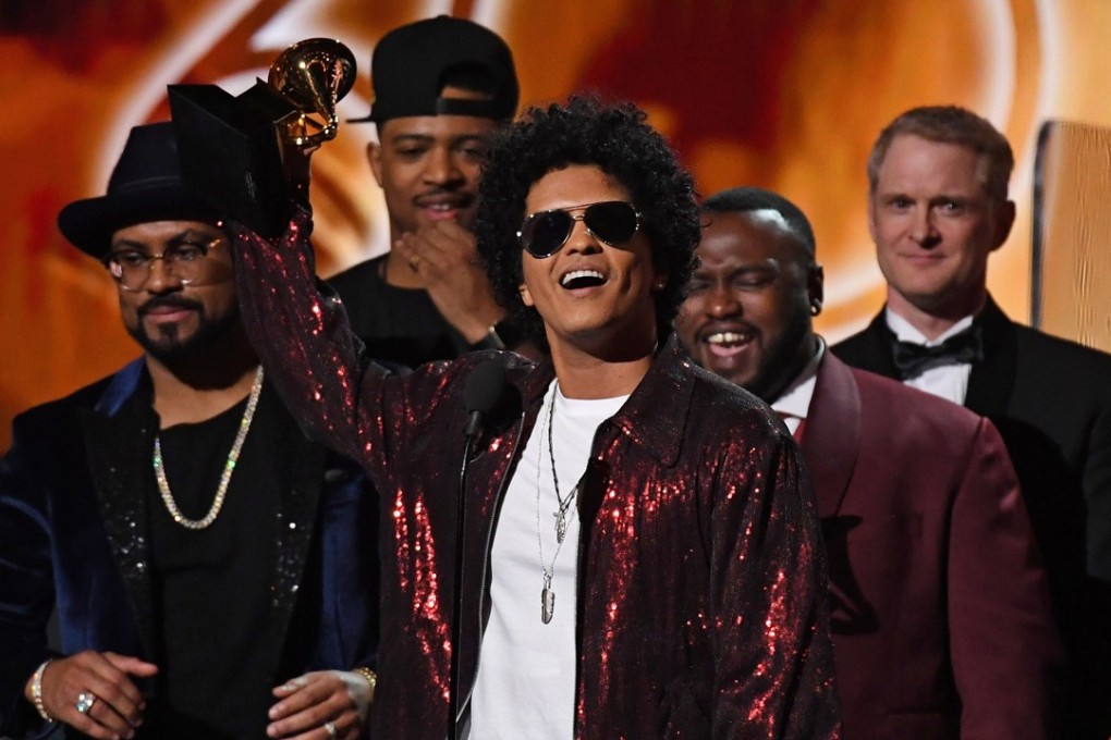 Bruno Mars receives his Grammy for Album of the Year. Photo: AFP