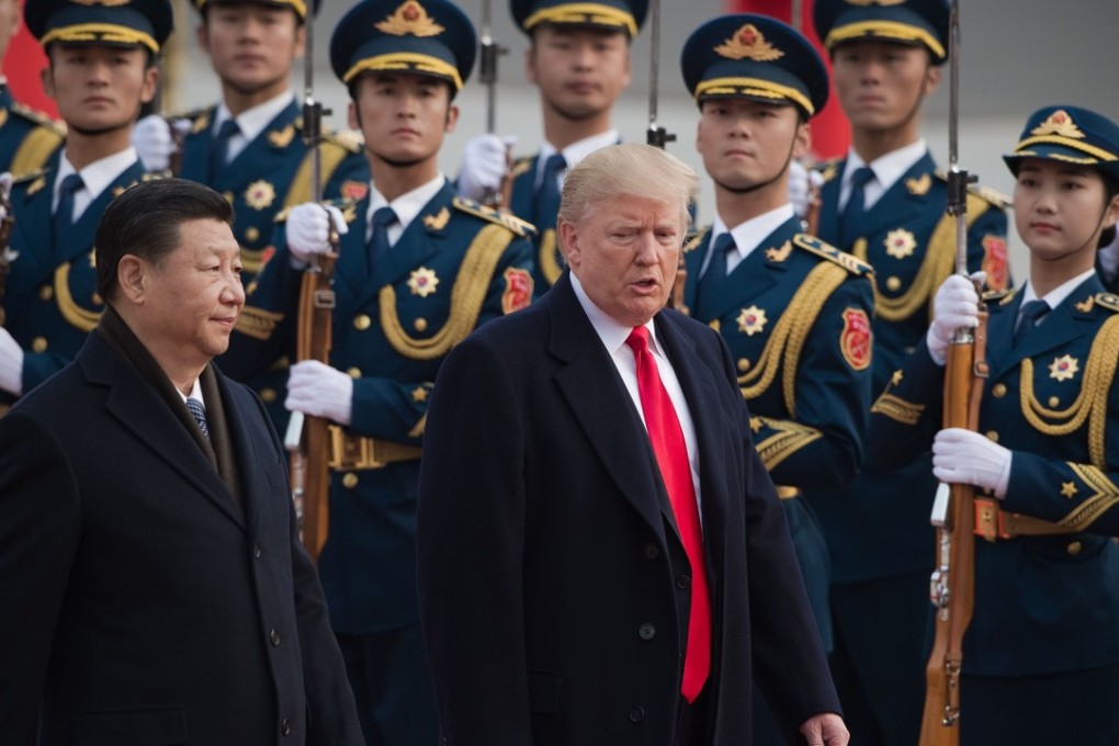 China's President Xi Jinping and US President Donald Trump walk past Chinese guards of honour during a welcome ceremony in Beijing in November. The apparent personal rapport between Trump and Xi had not prevented the US president from instituting tariffs on specific products in the past week and threatening to do more. Photo: AFP