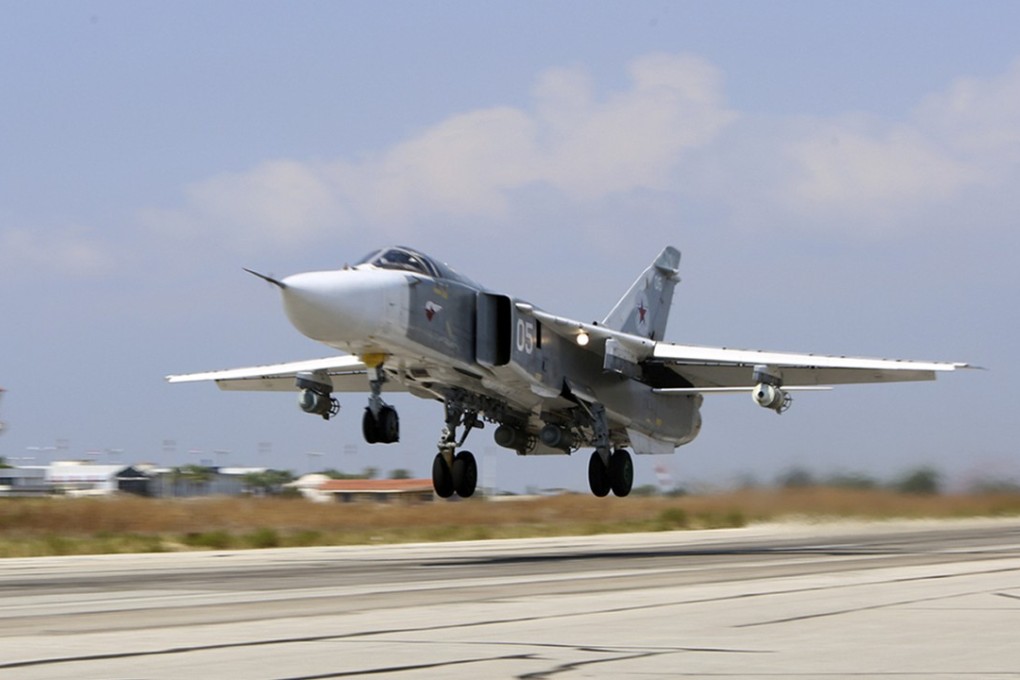 The US Navy says that a Russian Su-24 jet (similar to the one pictured; photo taken in October 2015) hounded a US jet in international airspace for two hours and 40 minutes, often flying dangerously close and invading its flightpath. Photo: Komsomolskaya Pravda via AP