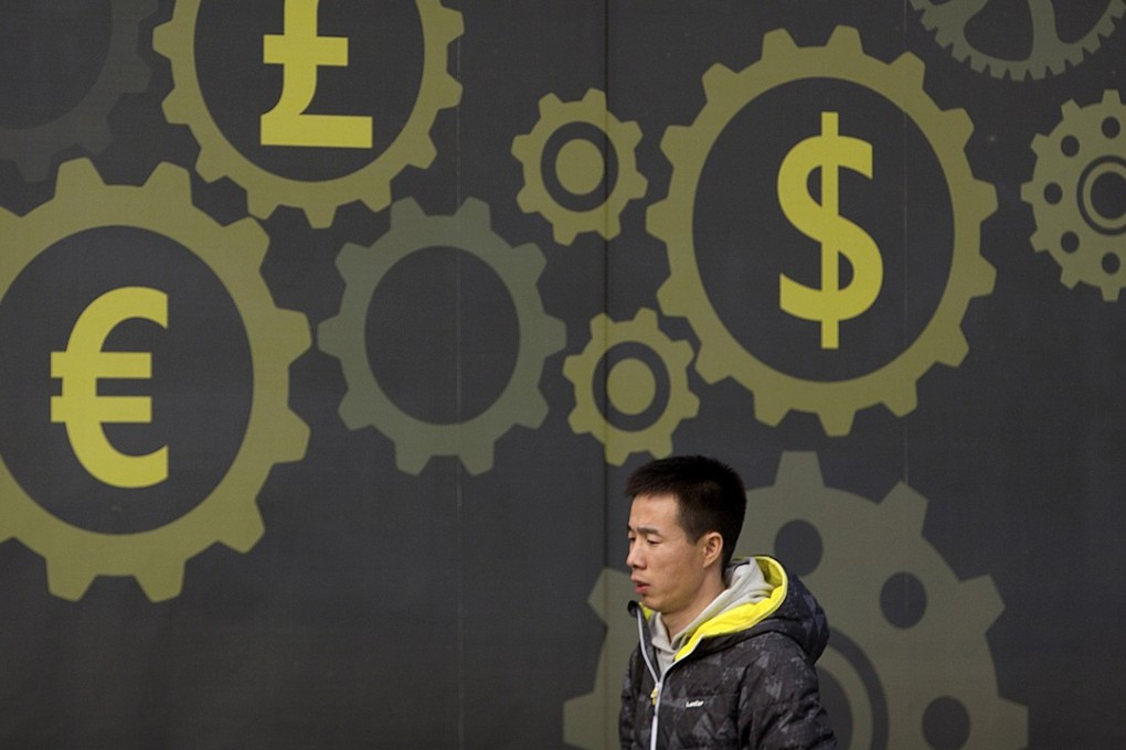 A weaker currency is seen as a major boost for exporting nations. A man walks past a display showing symbols for world currencies on the exterior of a bank in Beijing. Photo: AP