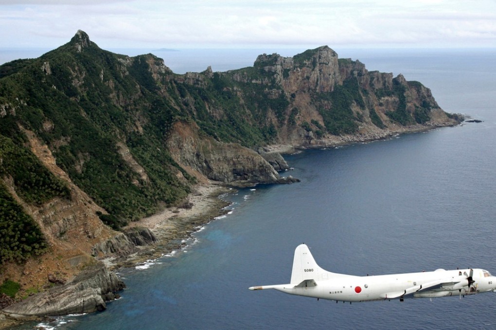 A Japanese surveillance plane flies over the disputed islands in the East China Sea, called the Senkakus in Japan and Diaoyus in China. Japan has set up a museum in Tokyo on territories it claims it has inherent sovereignty over. Photo: AP/Kyodo News
