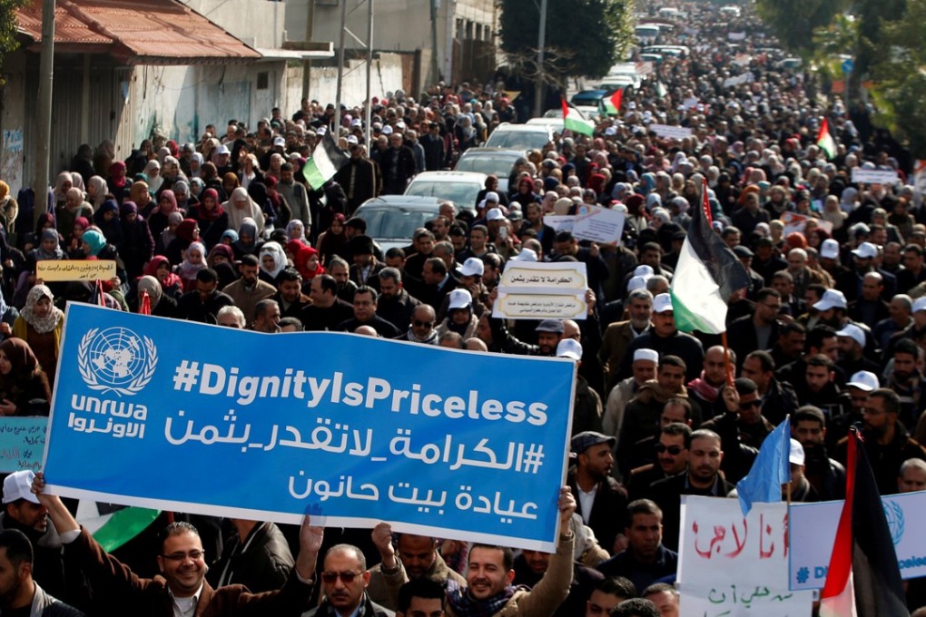 Palestinian employees of the United Nations Relief and Works Agency (UNRWA) hold a sign during a protest against a US decision to cut aid, in Gaza City on January 29, 2018. Photo: Reuters
