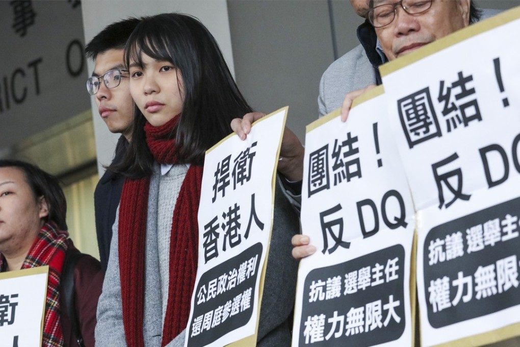 Joshua Wong Chi-fung (second left) and Agnes Chow Ting (third left) attends the Eastern District Council meeting at Sai Wan Ho. 30JAN18 SCMP / Felix Wong