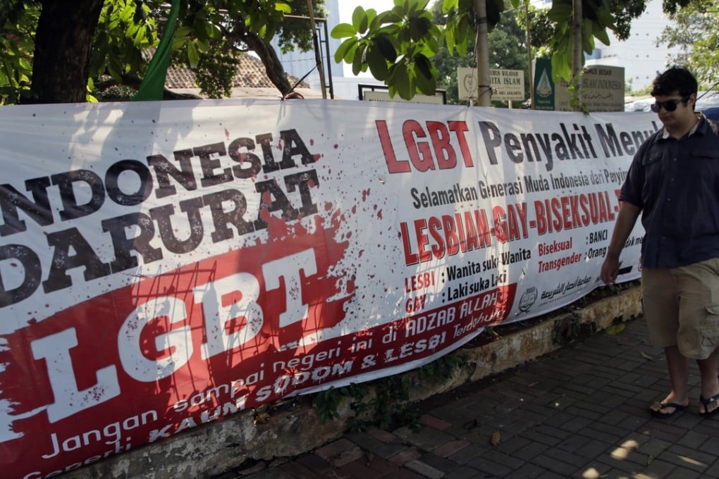 A man walks past an anti-LGBT banner erected by an ultra-conservative Islamic group in Jakarta. Photo: AP