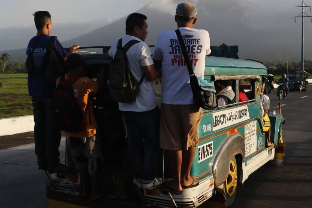 Passengers ride a jeepney, a popular and uniquely Filipino mode of mass transport, which is being phased out by the government. Photo: EPA