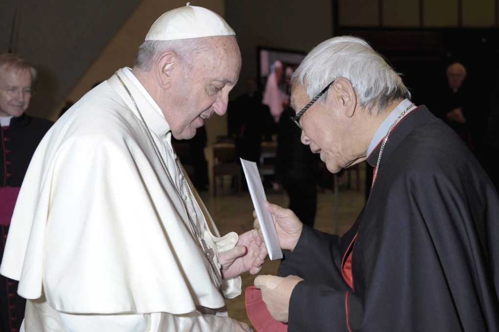 Retired archbishop of Hong Kong Cardinal Joseph Zen hands a letter to Pope Francis at the end of his weekly general audience in Paul VI, at the Vatican. Photo: L’Osservatore Romano/pool photo via AP
