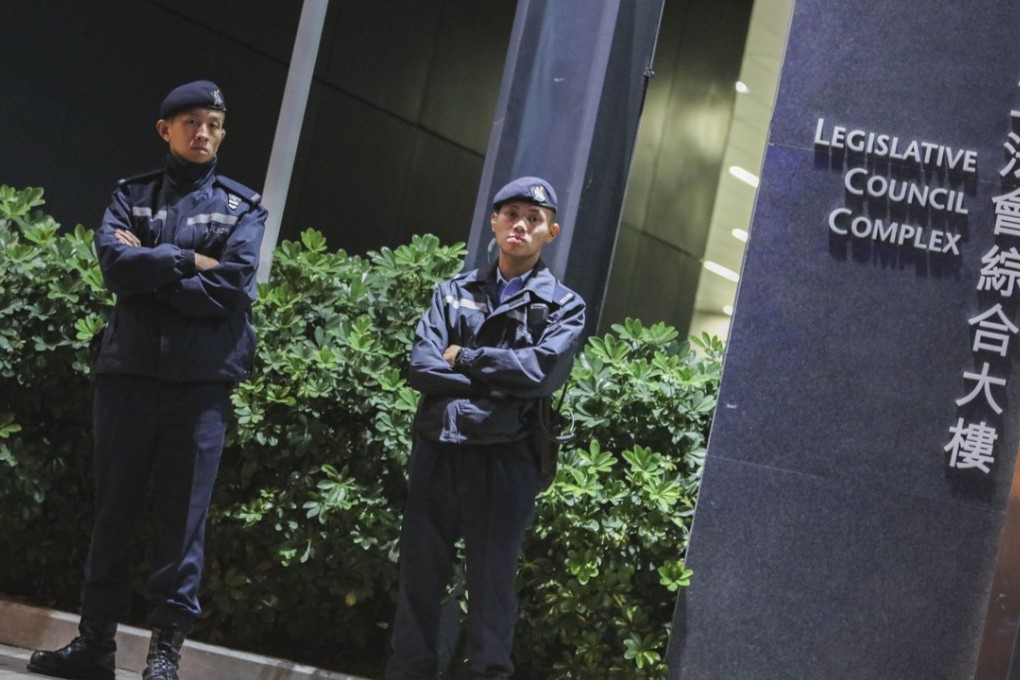 Police officers outside the Legislative Council in Tamar. Photo: Felix Wong