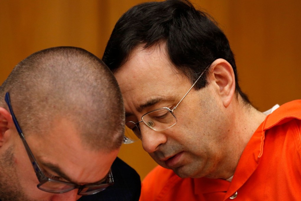 Former Michigan State University and USA Gymnastics doctor Larry Nassar with his defence lawyer Matt Newberg (L) during the sentencing phase in Eaton County Circuit Court on January 31, 2018 in Charlotte, Michigan. Prosecutors said at least 65 victims were to confront Nassar in court, in the last of three sentencing hearings for the disgraced doctor who molested young girls and women for two decades in the guise of medical treatment. Photo: AFP