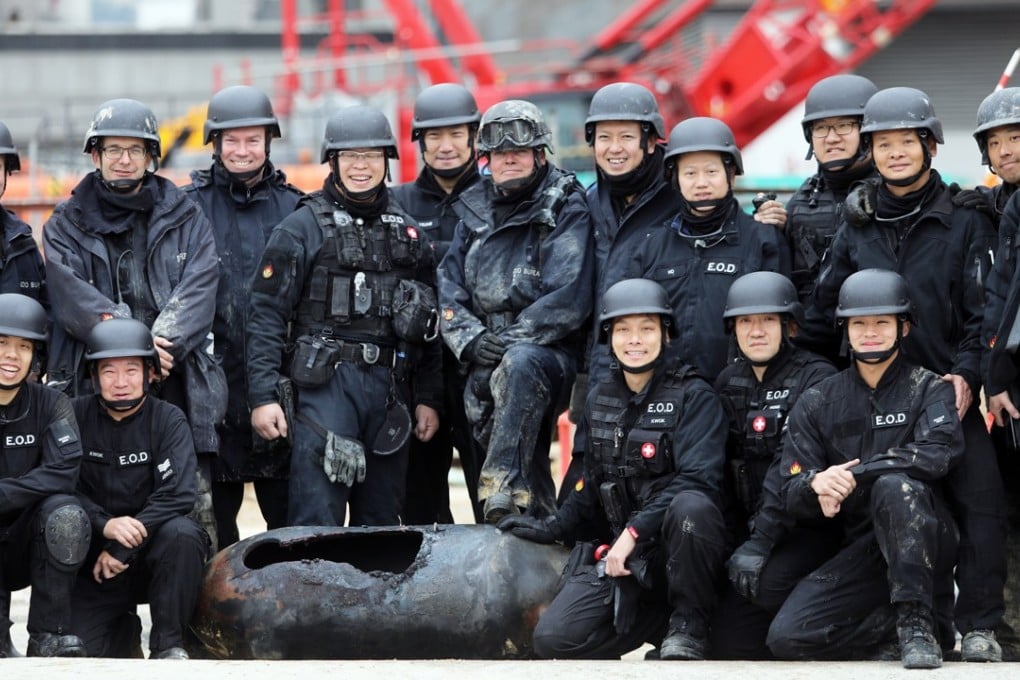 Bomb disposal officers with the disarmed bomb. Photo: Sam Tsang